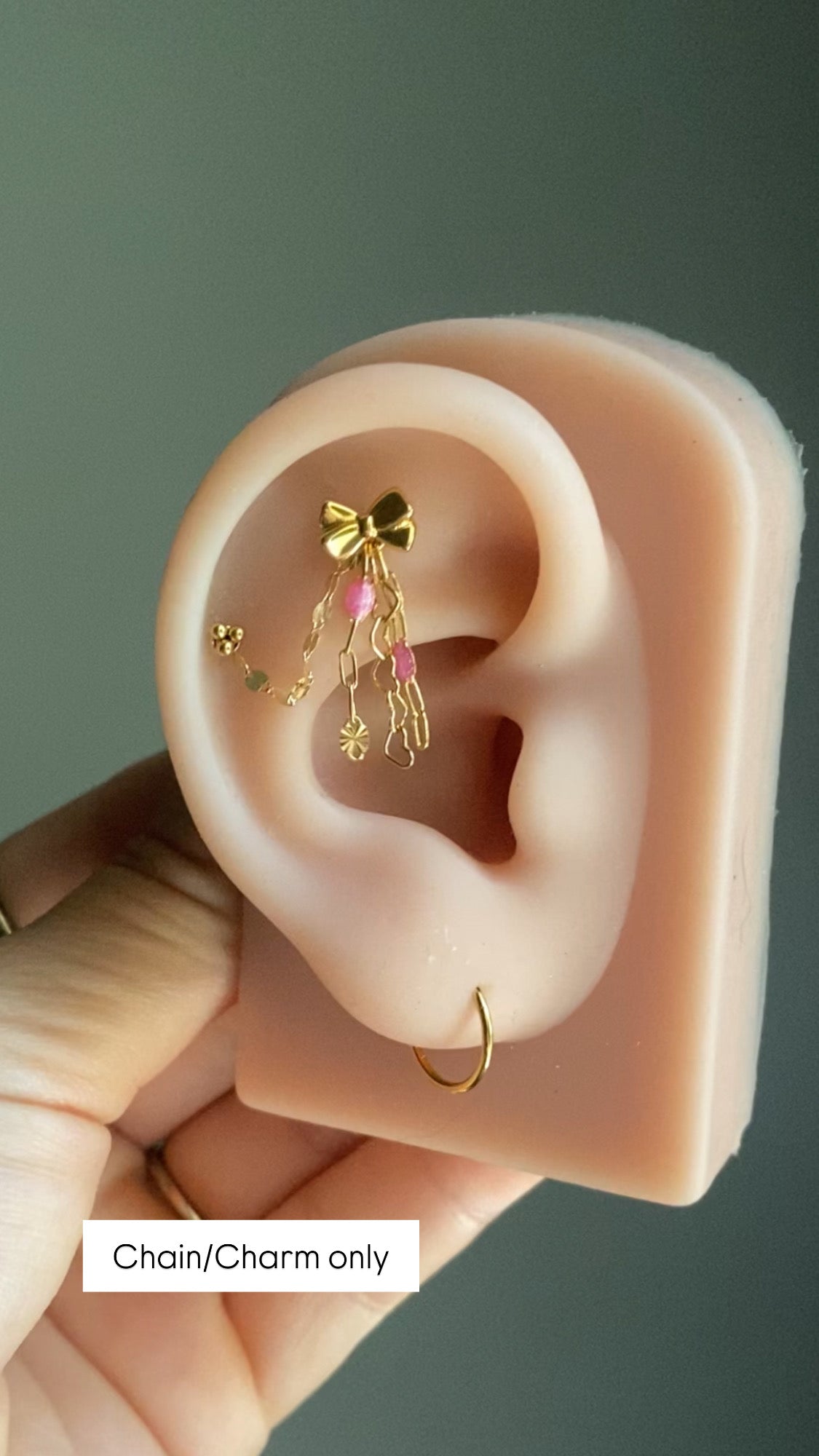 Handmade 14kt gold filled ear chain charm featuring a dainty heart dangle, pink glitter enamel starburst chain, and dapped leaf chain accents.