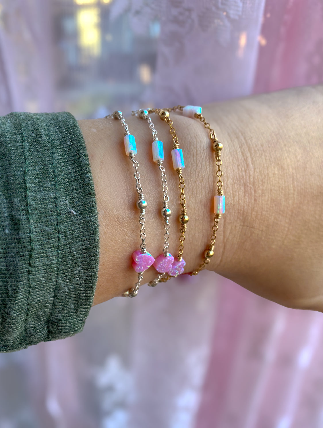Handmade opal charm chain bracelet with iridescent gemstones, shown stacked on wrist for styling inspiration, available in gold filled and sterling silver