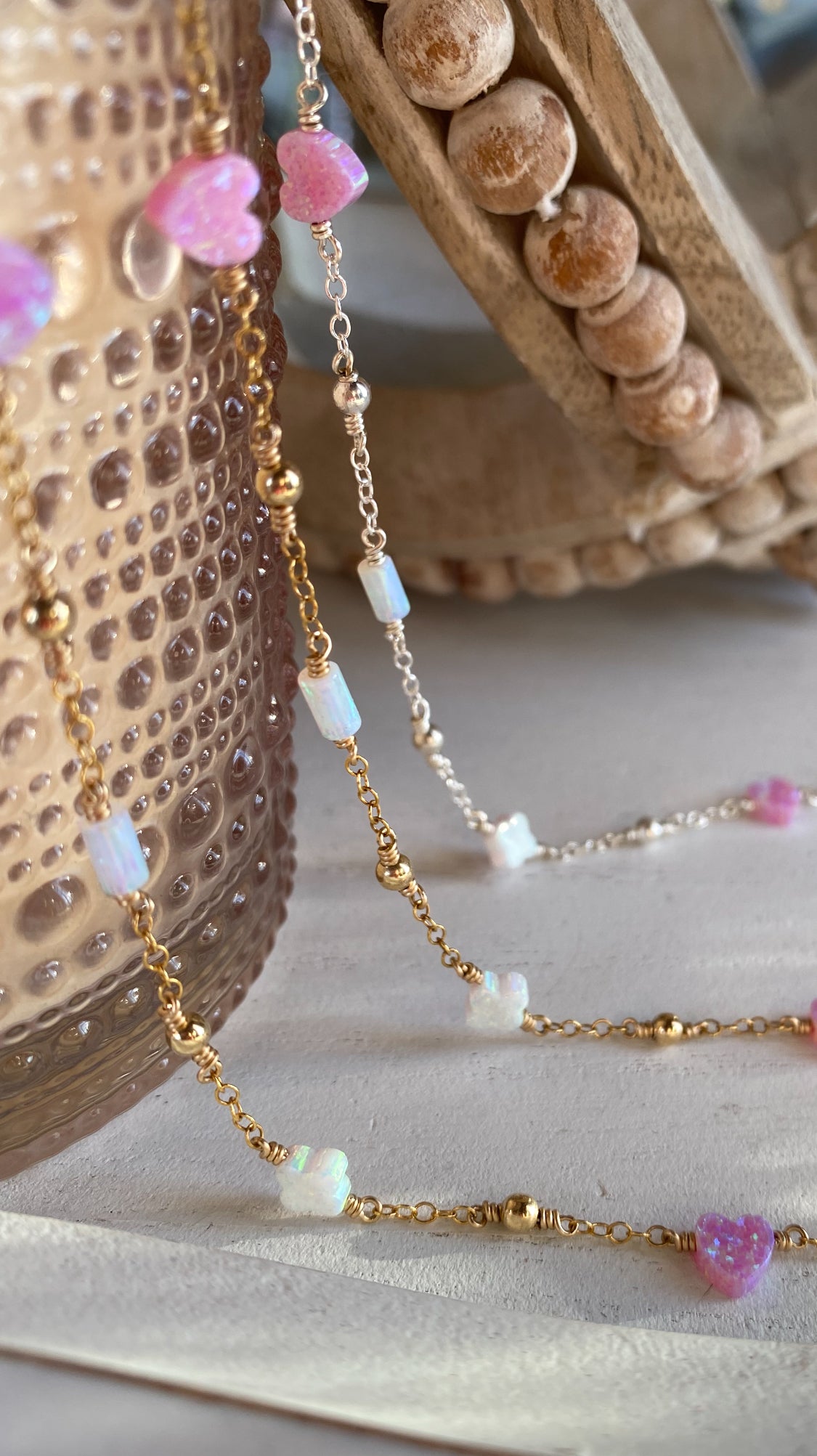 Handmade opal charm chain bracelet with iridescent gemstones, shown on a display for styling inspiration, available in gold filled and sterling silver