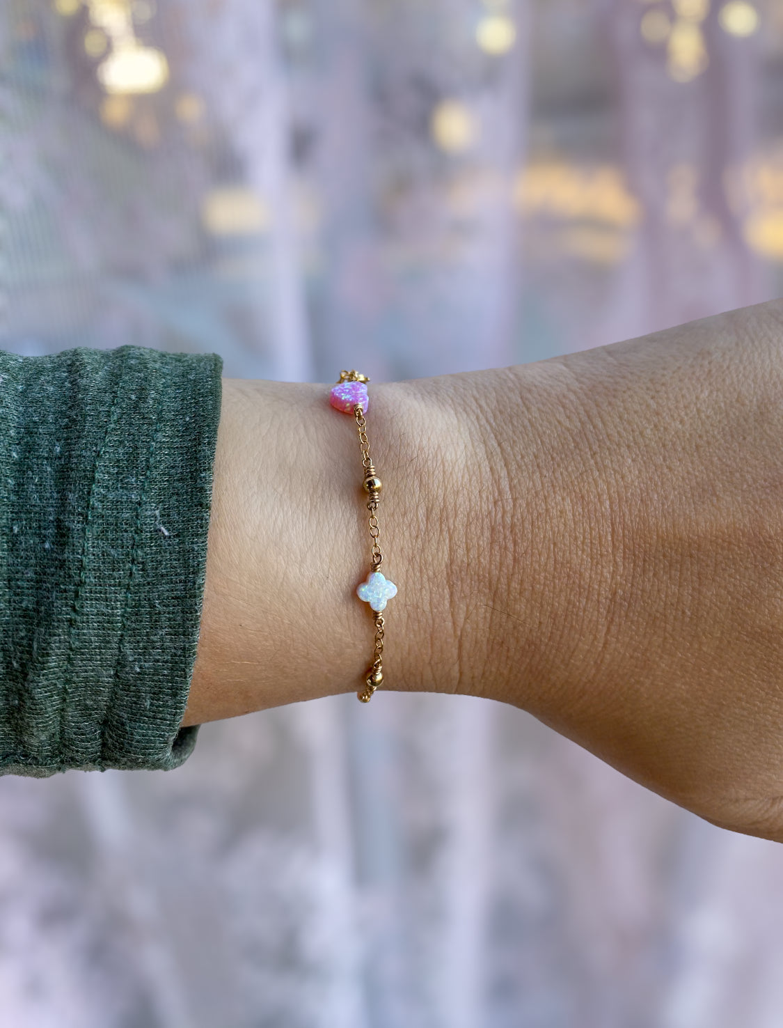 Handmade opal charm chain bracelet with iridescent gemstones, shown stacked on wrist for styling inspiration, available in gold filled and sterling silver