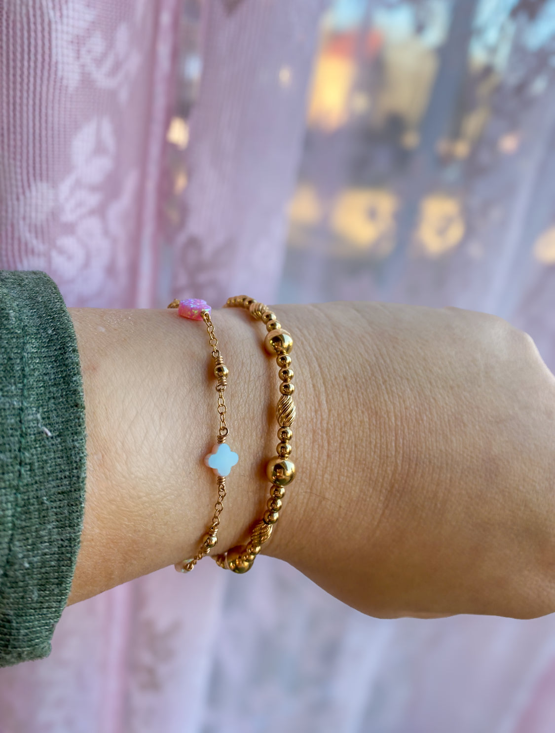 Handmade opal charm chain bracelet with iridescent gemstones, shown stacked on wrist for styling inspiration, available in gold filled and sterling silver and showing one of our beaded gold filled bracelets 